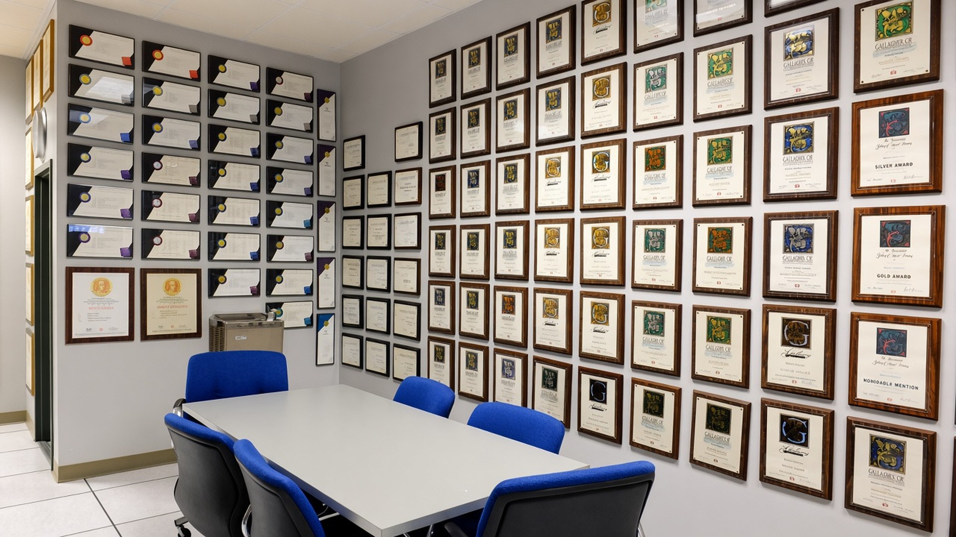 The awards room at Broudy Printing, with its conference table and walls of framed printing awards